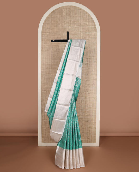 Turquoise Blue floral jaal jacquard budget silk saree, contrast traditional zari border, and intricate pallu