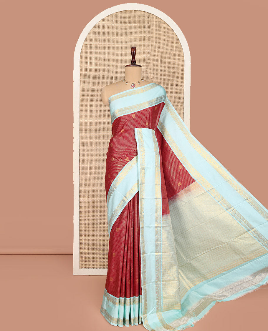 Red Budget Silk Saree, Elegantly Highlighted with Peacock-Chakram Zari Buttas and Checks All Over Its Body, Complemented by a Contrast Rettai Pettu Border of Traditional Designs, Scintillating Pallu, and Paired with a Contrast Blouse
