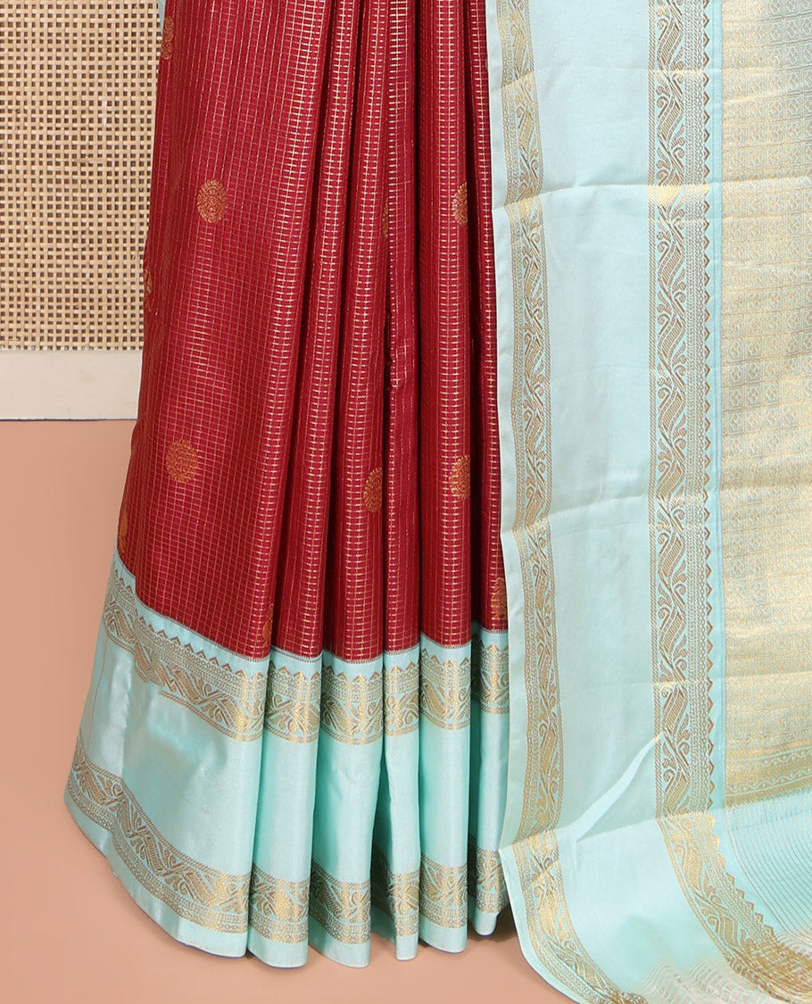 Red Budget Silk Saree, Elegantly Highlighted with Peacock-Chakram Zari Buttas and Checks All Over Its Body, Complemented by a Contrast Rettai Pettu Border of Traditional Designs, Scintillating Pallu, and Paired with a Contrast Blouse