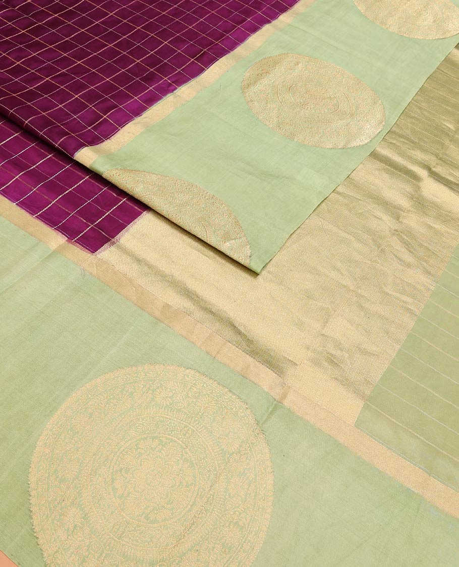 Purple Raw Mango Silk Saree Enthralled with Checks, Features a Contrast Chakram Motifs Border, a Zari-Elevated Pallu, and Paired with a Contrast Blouse
