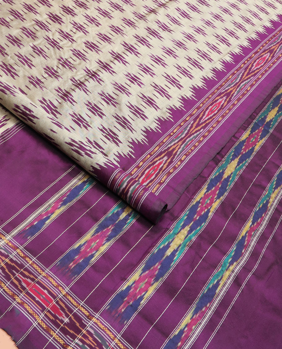 Grey Ikkat Silk Saree Highlighted with Ikkat Buttas, Featuring a Contrast Ikkat Temple Border in Ikkat Weave, and a Pallu Showcasing Ikkat Texture and Stripes
