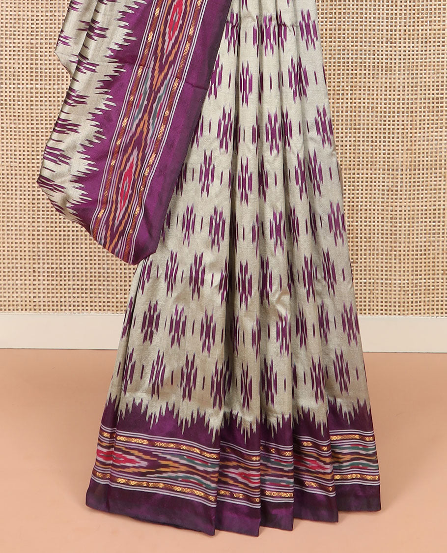 Grey Ikkat Silk Saree Highlighted with Ikkat Buttas, Featuring a Contrast Ikkat Temple Border in Ikkat Weave, and a Pallu Showcasing Ikkat Texture and Stripes