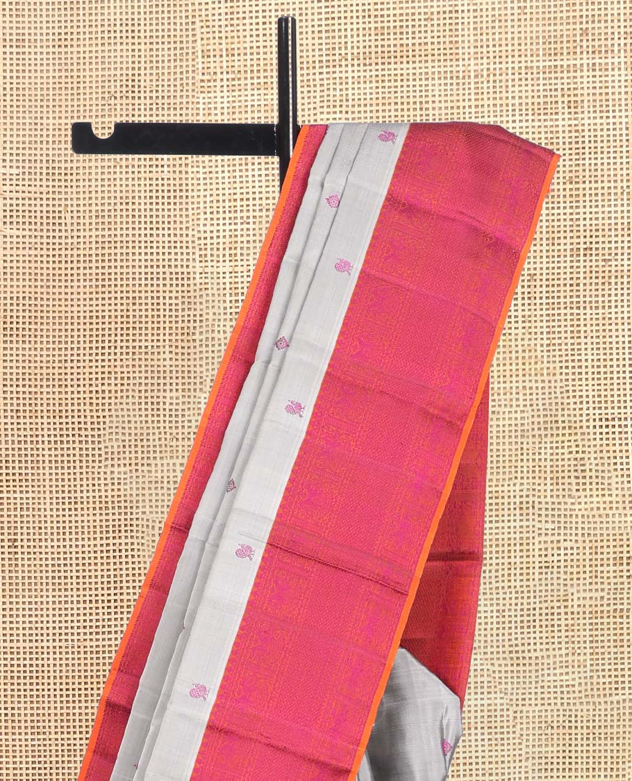 Grey Kanchipuram Silk Saree, Subtly Sparkled with Mayil-Chakram Buttas, a Contrast Border of Thilakam Mokku, Iruthalai Pakshi, and Kuyil Kann, Jaal Pallu, and a Contrast Blouse