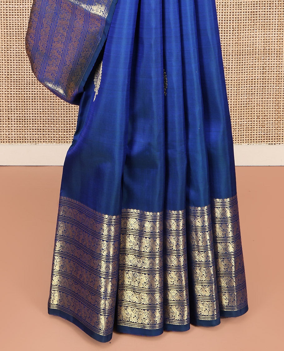 Blue Kanchipuram Silk Saree, Decorated with Zari Buttas All Over Its Body, Highlighted by a Zari Border of Salngai, Muthu, Mayil, and Kuthirai Designs, Grand Jaal Pallu, and Paired with a Matching Blouse