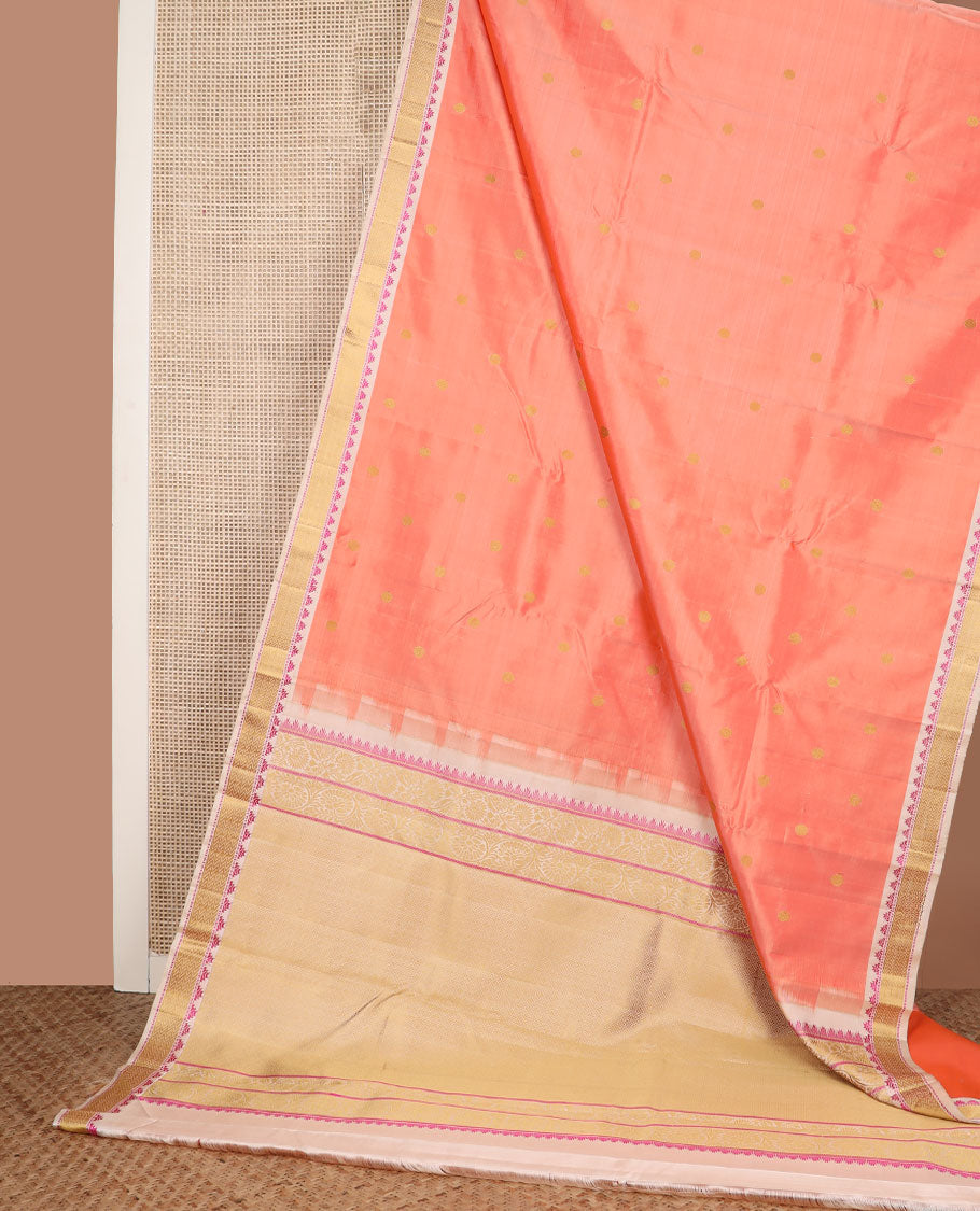 Peach rudraksham buttas Kanchipuram silk saree, contrast border of thazampoo rekku, muthu, and vanki designs, and jaal pallu