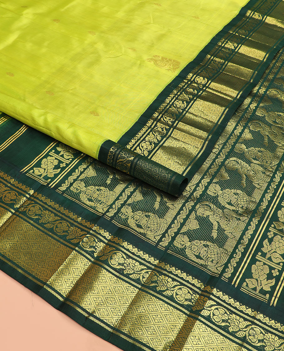 Green zari buttas Kanchipuram silk saree, contrast korvai border of thilakam mokku, kodi visiry, and jaal designs, and pallu of ancient human figurines