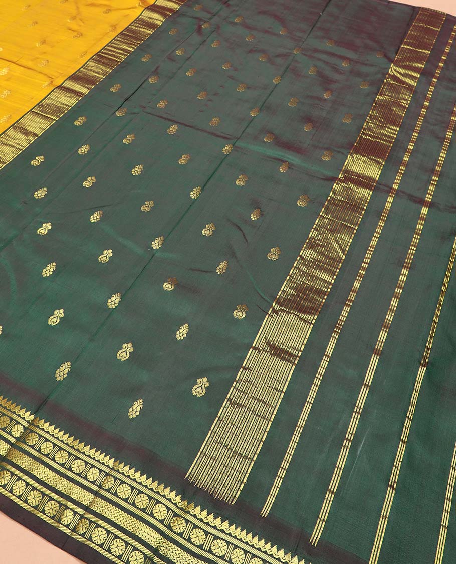 Yellow zari buttas Kanchipuram silk saree, contrast one-sided thazampoo rekku border of thilakam mokku, banaras, rudraksham and vanki designs, and zari design pallu