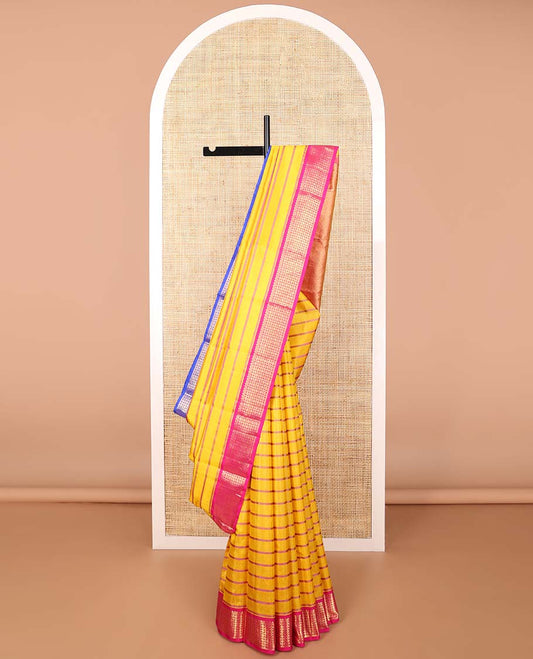 Yellow striped kancheepuram silk saree with contrast border of thilakam mokku, banaras, paun design & zari design pallu