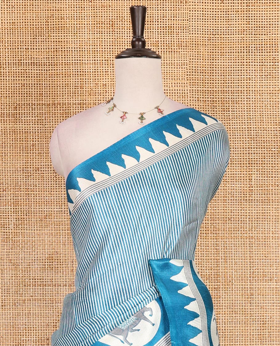 Cream-blue vertically striped khadi cotton saree, contrast Pichwai cow printed temple border, Pichwai cow print pallu, and jaal printed blouse
