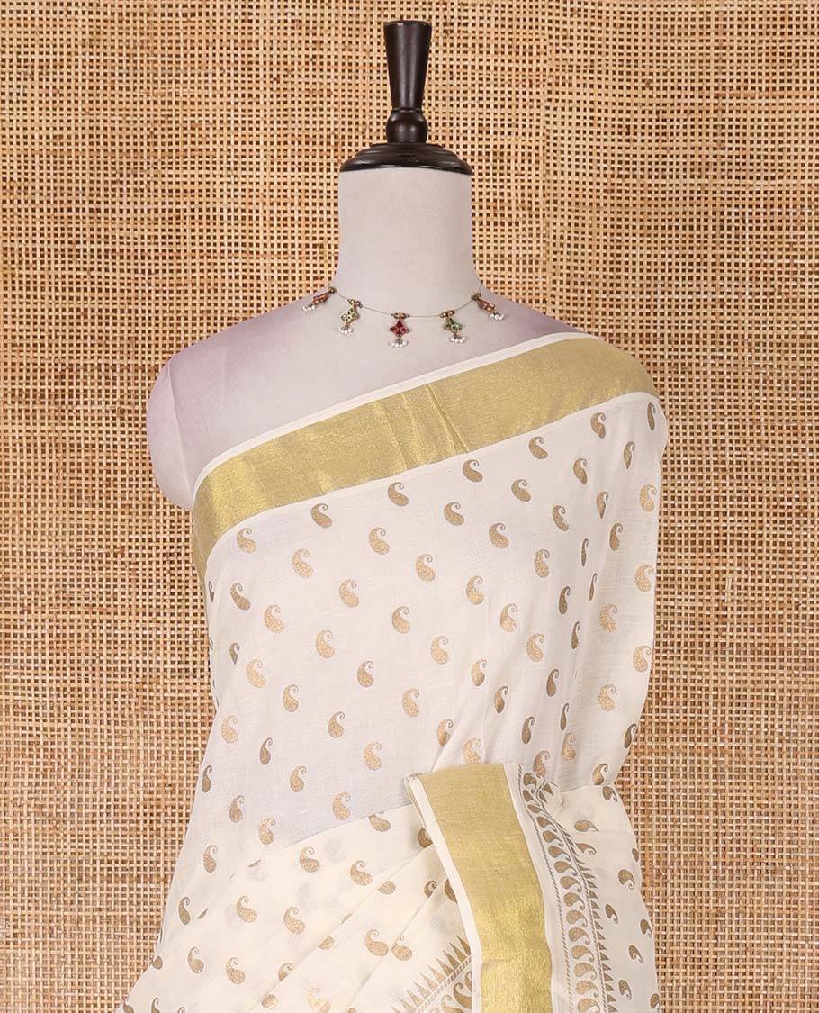 Cream manga butta golden foil printed Kerala cotton saree, zari border, pallu of paisley motifs, and a matching blouse