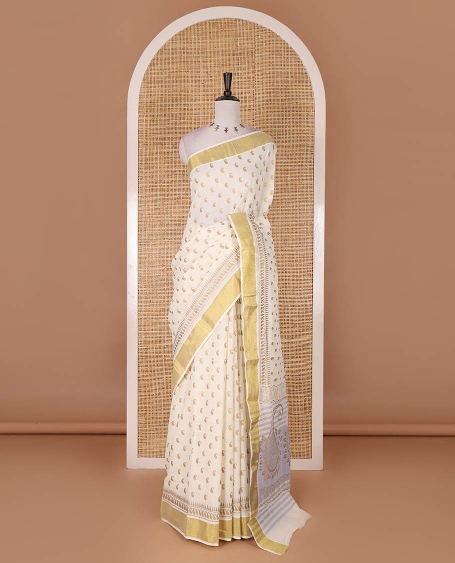 Cream manga butta golden foil printed Kerala cotton saree, zari border, pallu of paisley motifs, and a matching blouse
