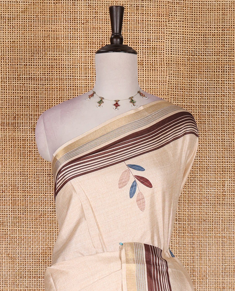 Chikku leaf themed printed soft tussar saree, contrast golden zari horizontally striped border, dual color textured pallu, and contrast plain blouse
