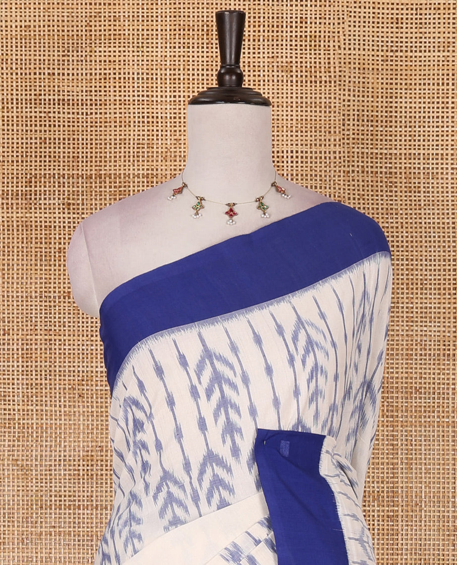 Half white leaf design ikkat cotton saree, contrast plain border, ikkat chevron pallu, and contrast plain blouse