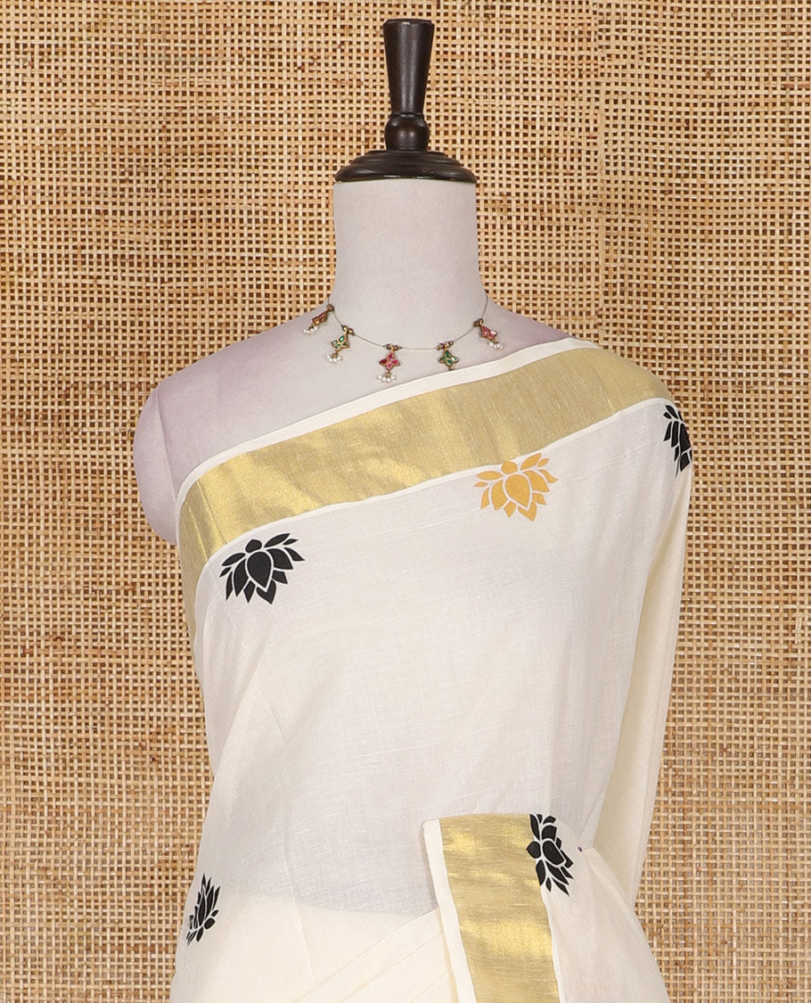 Half-white lotus motifs printed Kerala cotton saree, gold zari border, lotus motifs printed pallu, and matching blouse