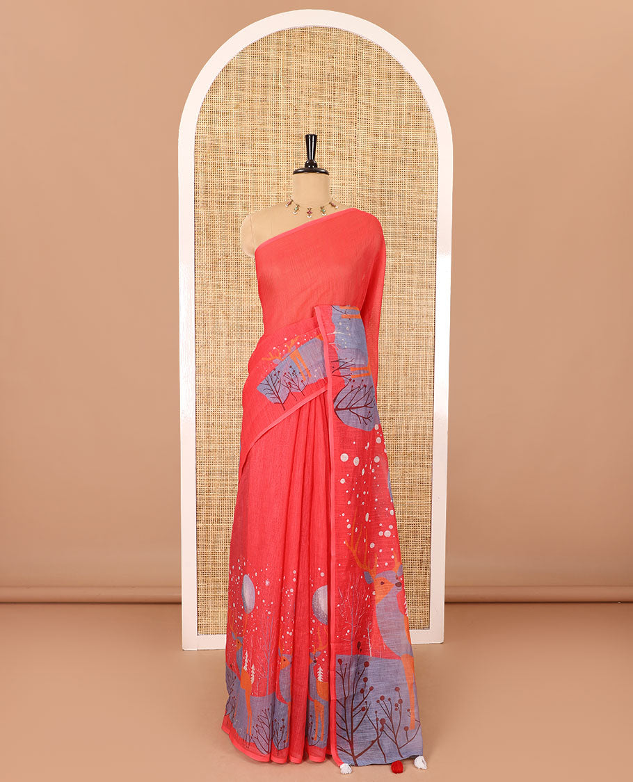 Borderless tomato pink Christmas-theme Snow-fall, moon, Christmas trees, and deer motifs printed linen cotton saree with a contrast printed blouse