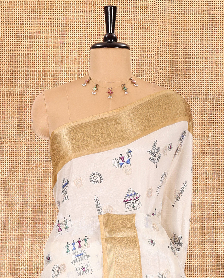 Half-white buttas with warli village motifs printed dola silk saree, contrast traditional zari border of paisleys, warli printed pallu, and a contrast printed blouse