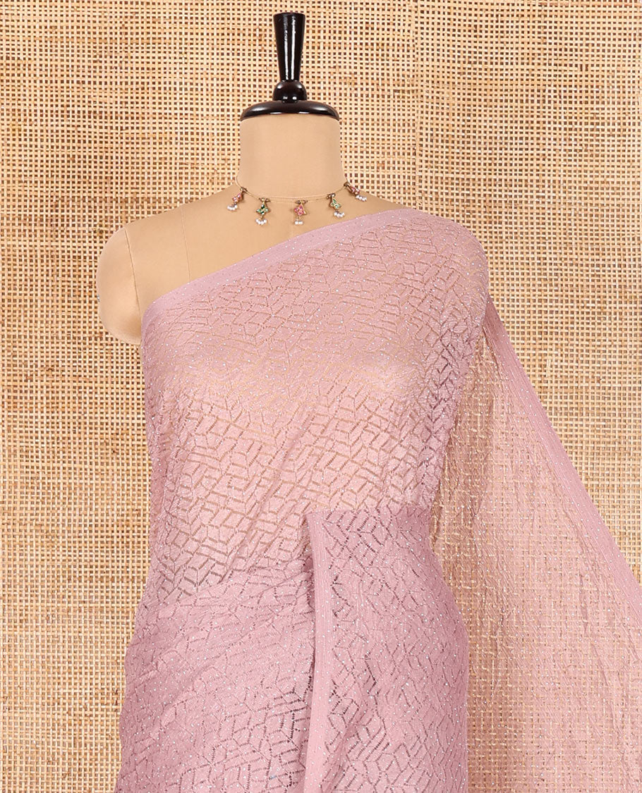 Borderless dusky pink sparkling glittered russel net saree, self-pallu and a floral print with zig-zag embroidered blouse