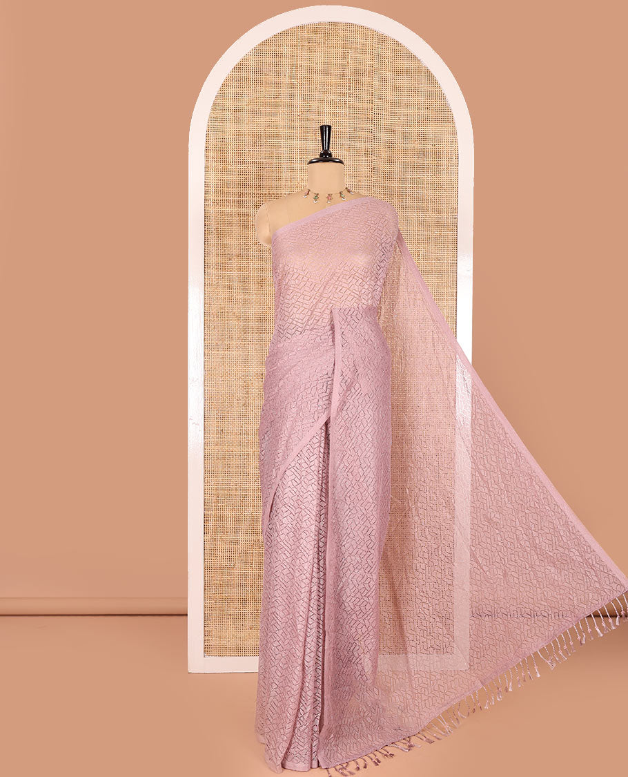 Borderless dusky pink sparkling glittered russel net saree, self-pallu and a floral print with zig-zag embroidered blouse