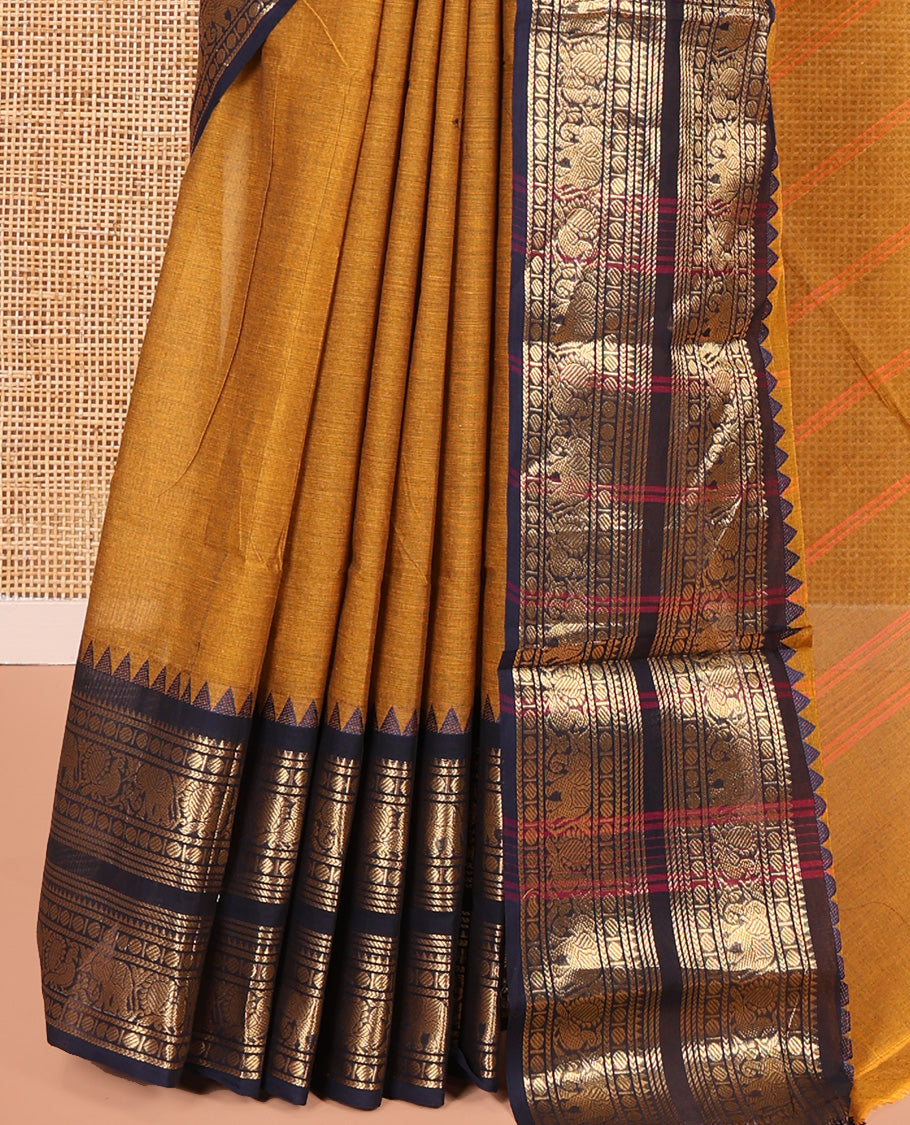 Mustard Plain Chettinad Cotton Saree, Complemented by a Contrast Rettai Pettu Zari Border of Thread-Temple, Coin, Elephant, and Peacock Designs, Subtly Striped Pallu, and Paired with a Matching Blouse