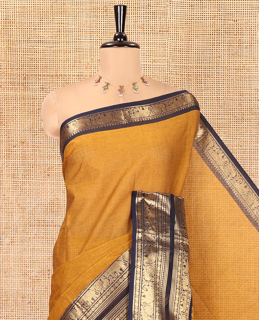Mustard Plain Chettinad Cotton Saree, Complemented by a Contrast Rettai Pettu Zari Border of Thread-Temple, Coin, Elephant, and Peacock Designs, Subtly Striped Pallu, and Paired with a Matching Blouse