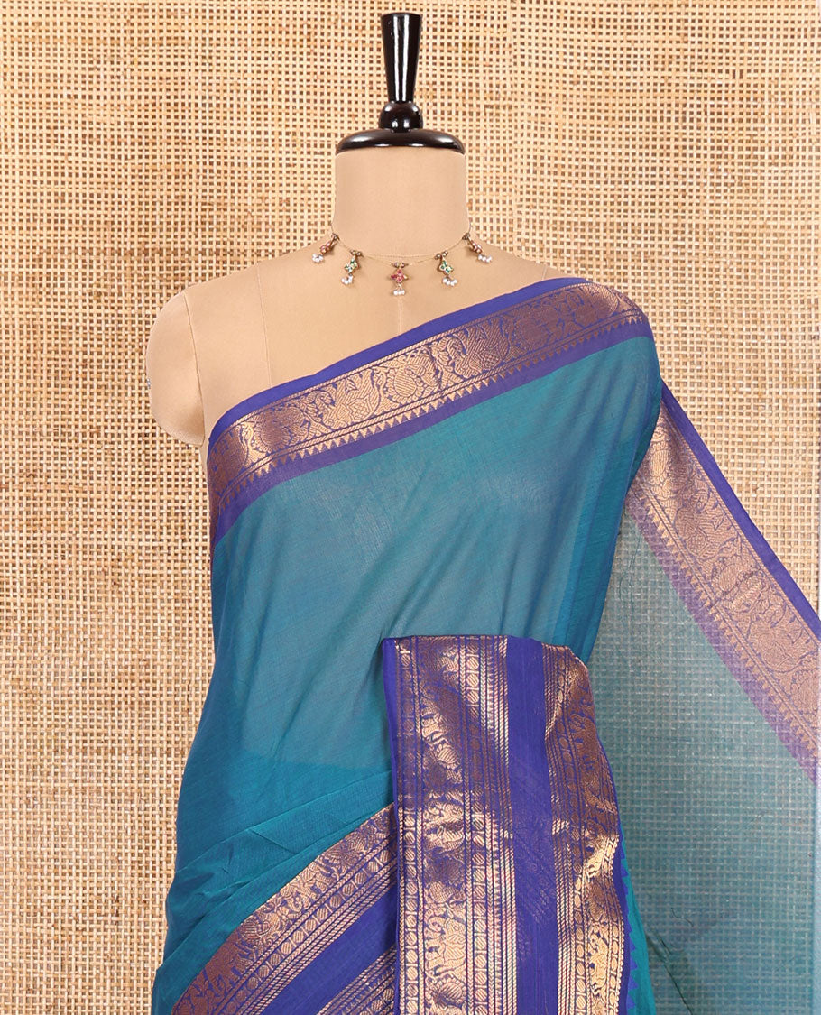 Blue Plain Chettinad Cotton Saree, Complemented by a Contrast Traditional Rettai Pettu Temple Border of Peacock-Elephant Designs, Subtly Striped Pallu, and Paired with a Matching Blouse