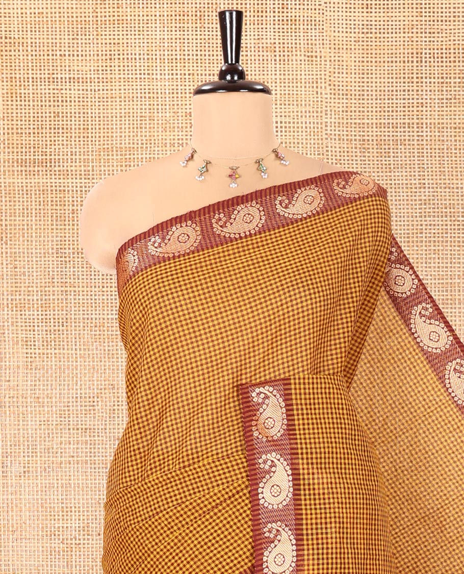 Mustard Chettinad Cotton Saree, Adorned with Checked Design on Its Body, Complemented by a Contrast Paisley Border, Subtly Striped Pallu, and Paired with a Matching Blouse