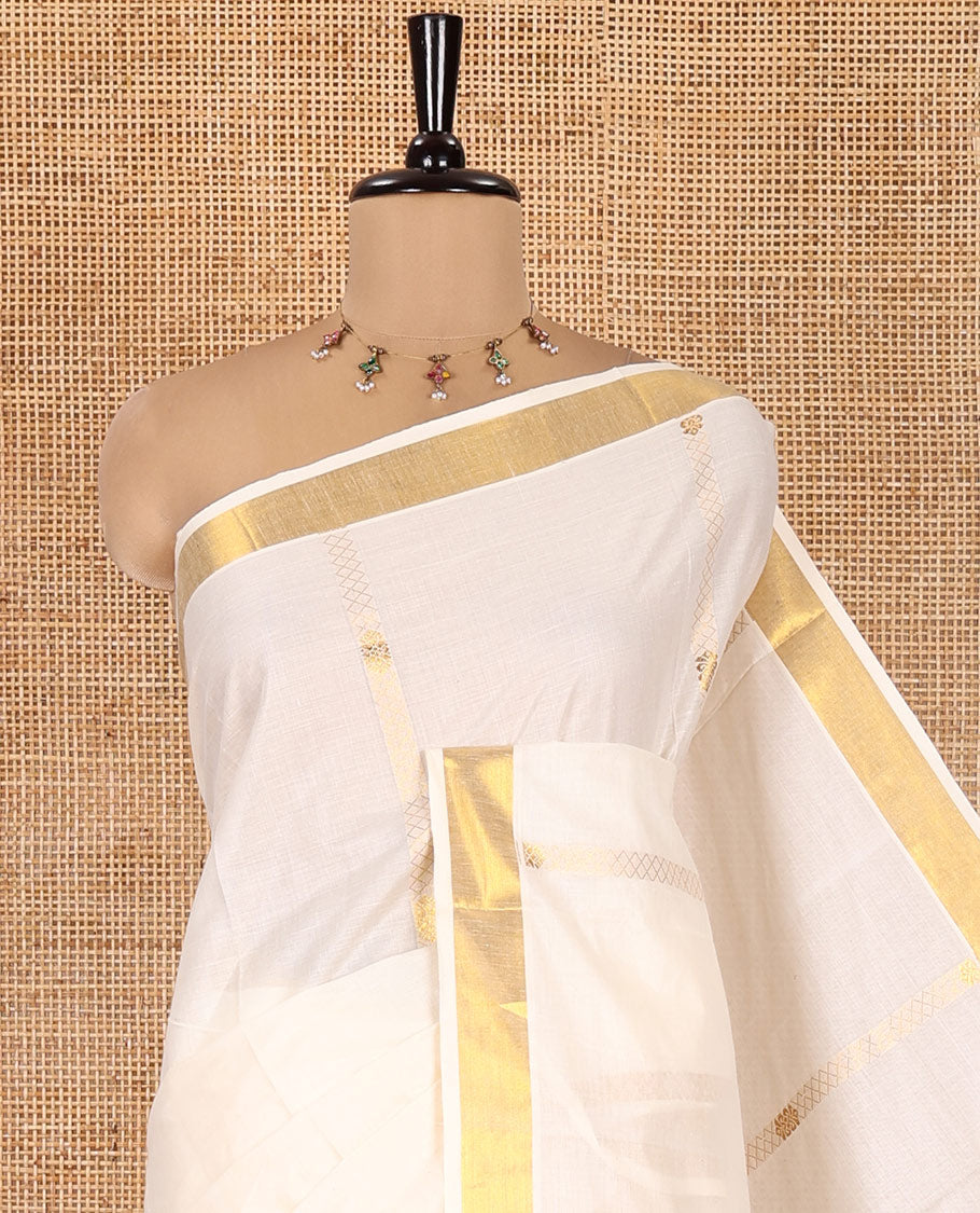 Cream Kerala Cotton Saree, Gleamed Up with Zari Stripes, a Zari Border, a Pallu of Chakram-Peacock Designs, and a Matching Blouse