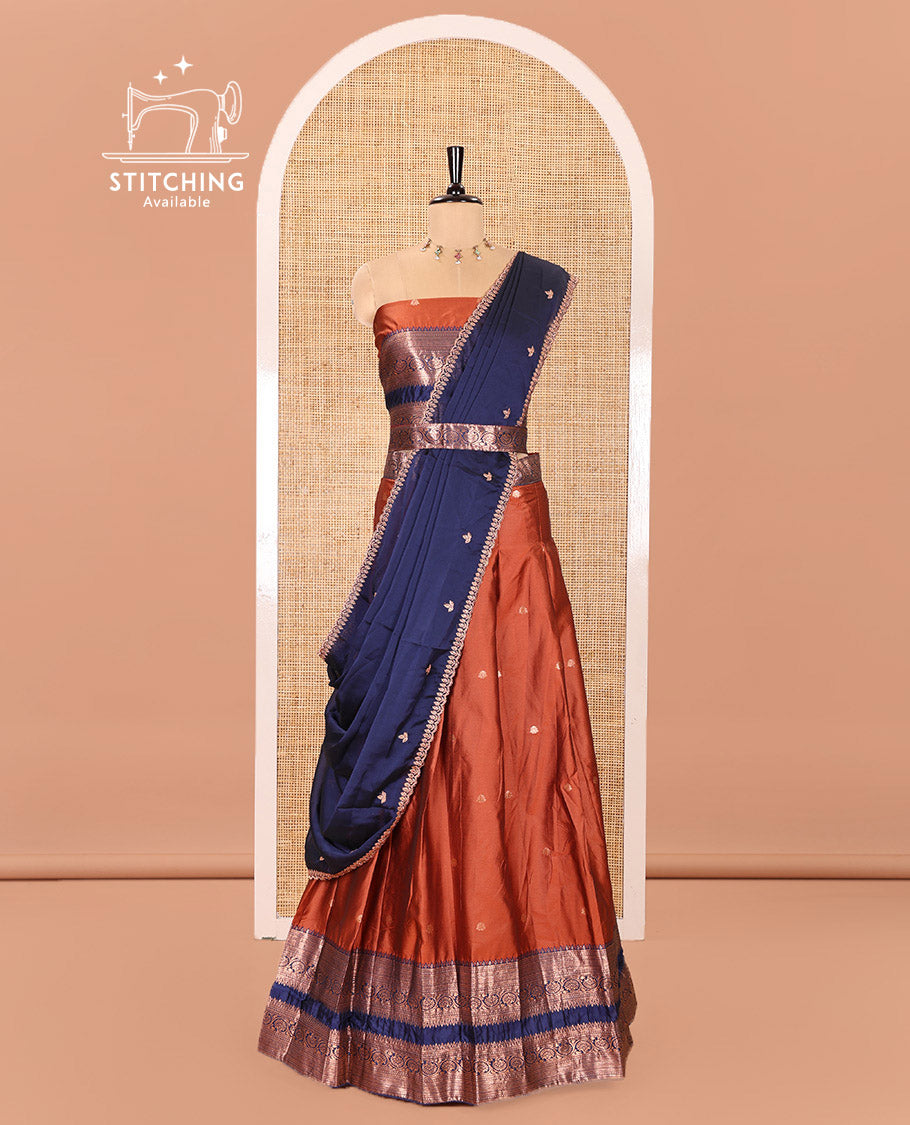 Rust and Blue Semi-Banarasi Half-Saree Featuring Zari Buttas Skirt, Complemented by Contrast Rettai Pettu, Traditional Border of Floral Creeper Designs, Paired with a Matching Blouse, and a Satin Georgette Embroidered Scallop Dhavani
