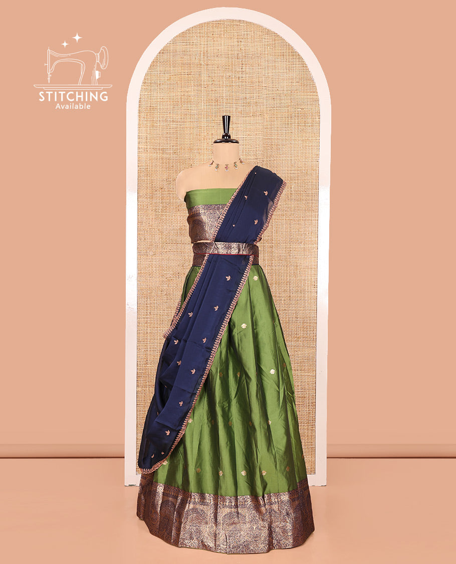 Leaf Green and Blue Semi-Banarasi Half-Saree, Beautifully Woven with Zari Buttas on Its Skirt, Complemented by a Contrast Geometric Patterns Zari Woven Border, Paired with a Matching Blouse, and a Contrast Satin Georgette Embroidered Scallop Dhavani