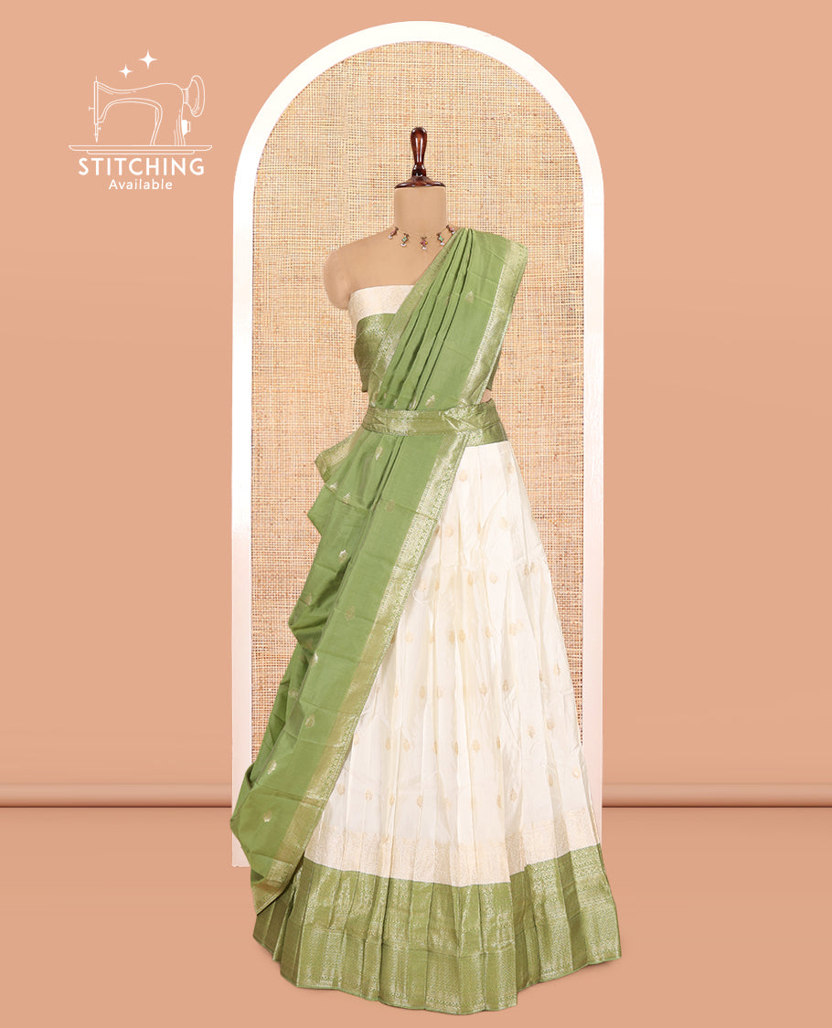 Cream-Olive Green Semi-Silk Half-Saree, Subtly Sparkled with Zari Buttas Skirt, a Contrast Traditional Zari Border, and a Contrast Dhavani