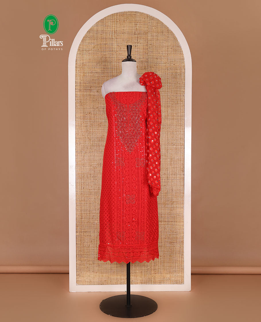 Red material churidar set, stone work with Schiffli style embroidered georgette top, American Crape bottom, and polka dotted printed mirror work dupatta