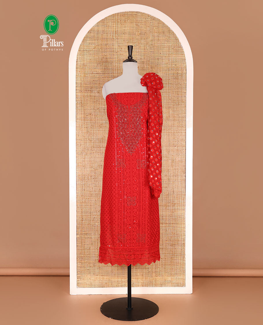 Red material churidar set, stone work with Schiffli style embroidered georgette top, American Crape bottom, and polka dotted printed mirror work dupatta