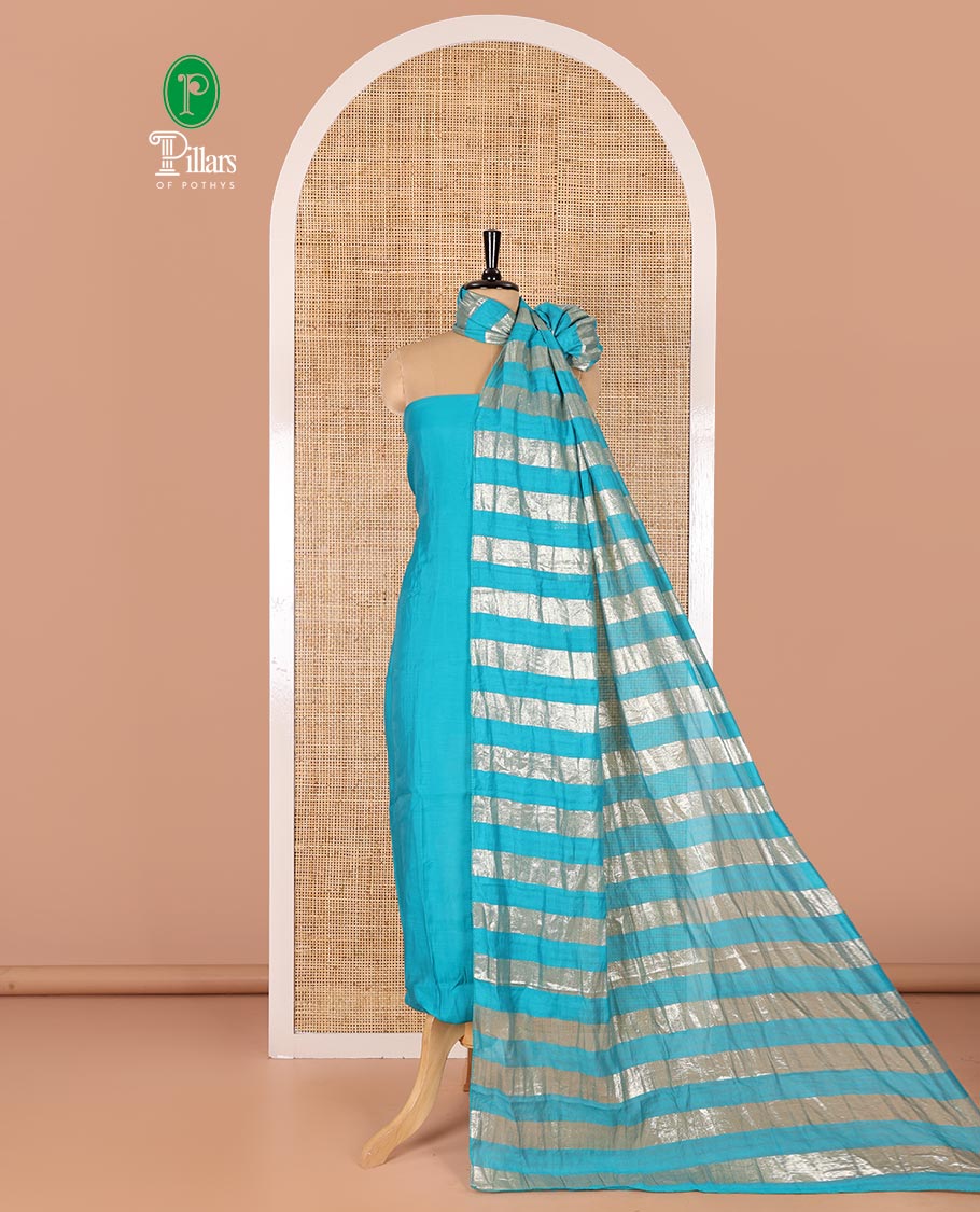 Blue material chudidar set, plain with pom-pom tasseled mul chanderi top, a matching bottom, and organza dupatta of stripes