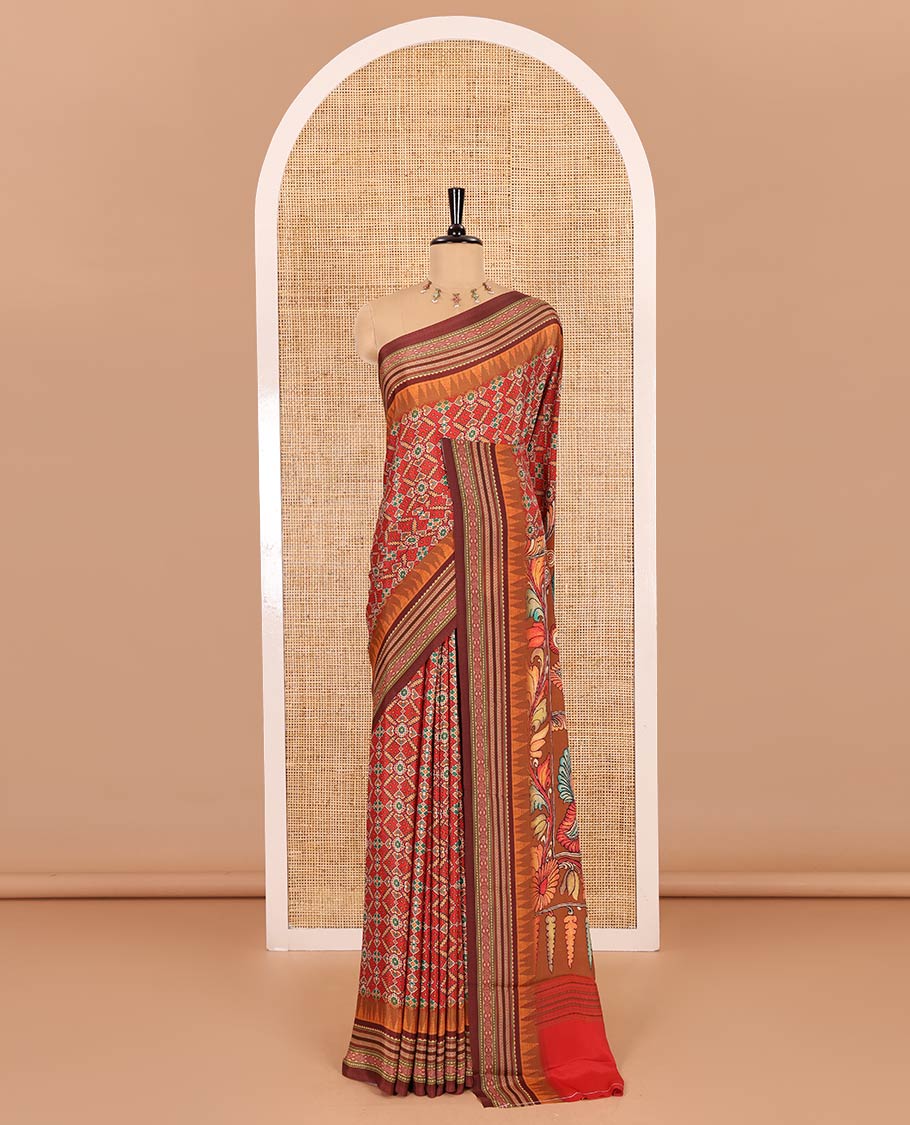Tomato red patola style geometric printed Italian Crepe saree, contrast temple ikkat printed border, Kalamkari printed pallu, and a printed bordered blouse
