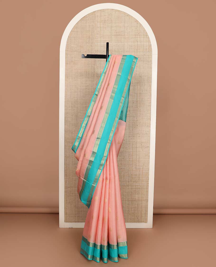 Pink buttas and micro-checked Vasundhara silk mix saree, contrast rettai pettu border of thilakam, banaras, muthu, and kodi visiry designs, and pallu of peacock feathers