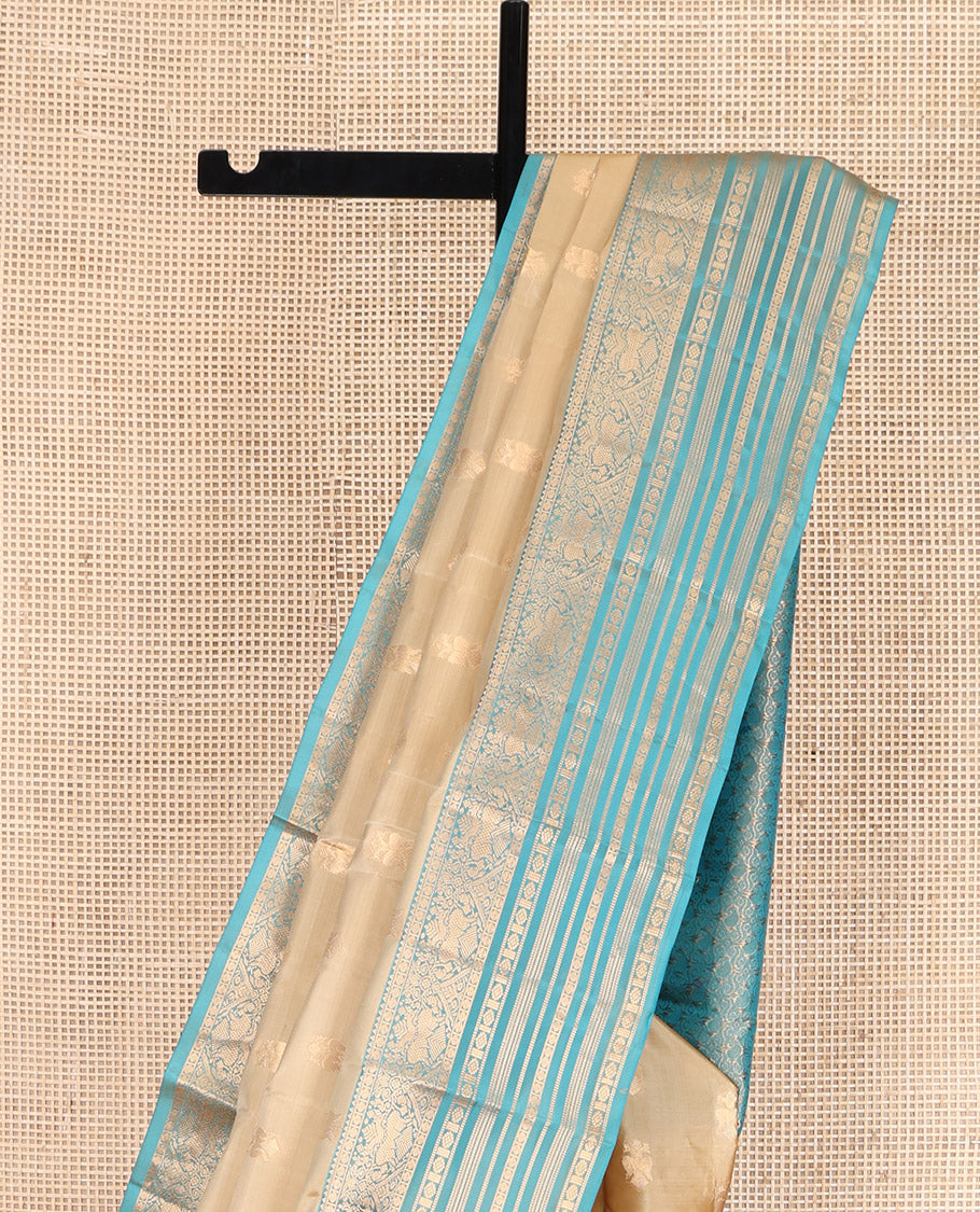 Gold Vasundhara Lite Silk Mix Saree, Bedecked with Iruthalai Pakshi Zari Buttas, Complemented by a Contrast Border of Rekku, Iruthalai Pakshi, Muthu, Laddu Kamalam, and Rudraksham, Opulently Embellished Pallu, and Paired with a Contrast Blouse