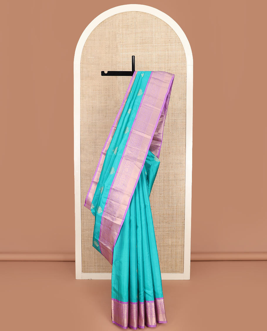 Blue Vasundhara Silk Saree Richly Detailed with Zari Buttas, Complemented by a Contrast Border of Thilakam Mokku, Kathir, Rudraksham, and Kodi Visiry Designs, Zari Designs Elevated Pallu, and Paired with a Contrast Zari-Bordered Blouse