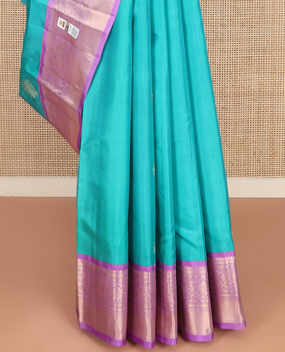 Blue Vasundhara Silk Saree Richly Detailed with Zari Buttas, Complemented by a Contrast Border of Thilakam Mokku, Kathir, Rudraksham, and Kodi Visiry Designs, Zari Designs Elevated Pallu, and Paired with a Contrast Zari-Bordered Blouse