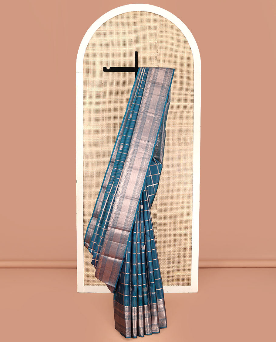 Blue Vasundhara Silk Saree, Enriched with Zari Butta Enclosed Checked Design All Over Its Body, Highlighted by Zari Border of Thilakam Mokku, Muthu, Mayil, Yaanai, and Mayil Kann Designs, Grand Jaal Pallu, and Paired with a Matching Blouse
