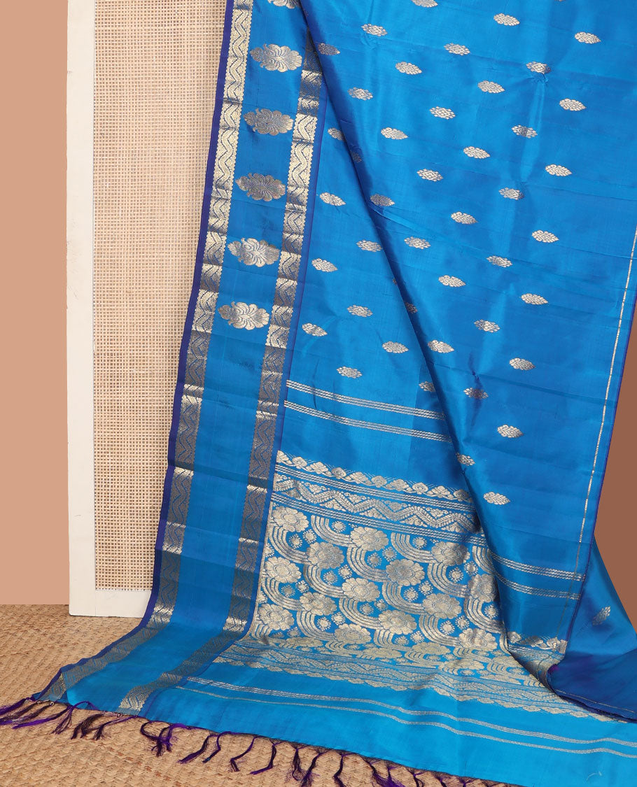 Blue zari buttas Kanchipuram silk saree, one-sided zari border of rekku, banaras, and neli designs, and floral design pallu