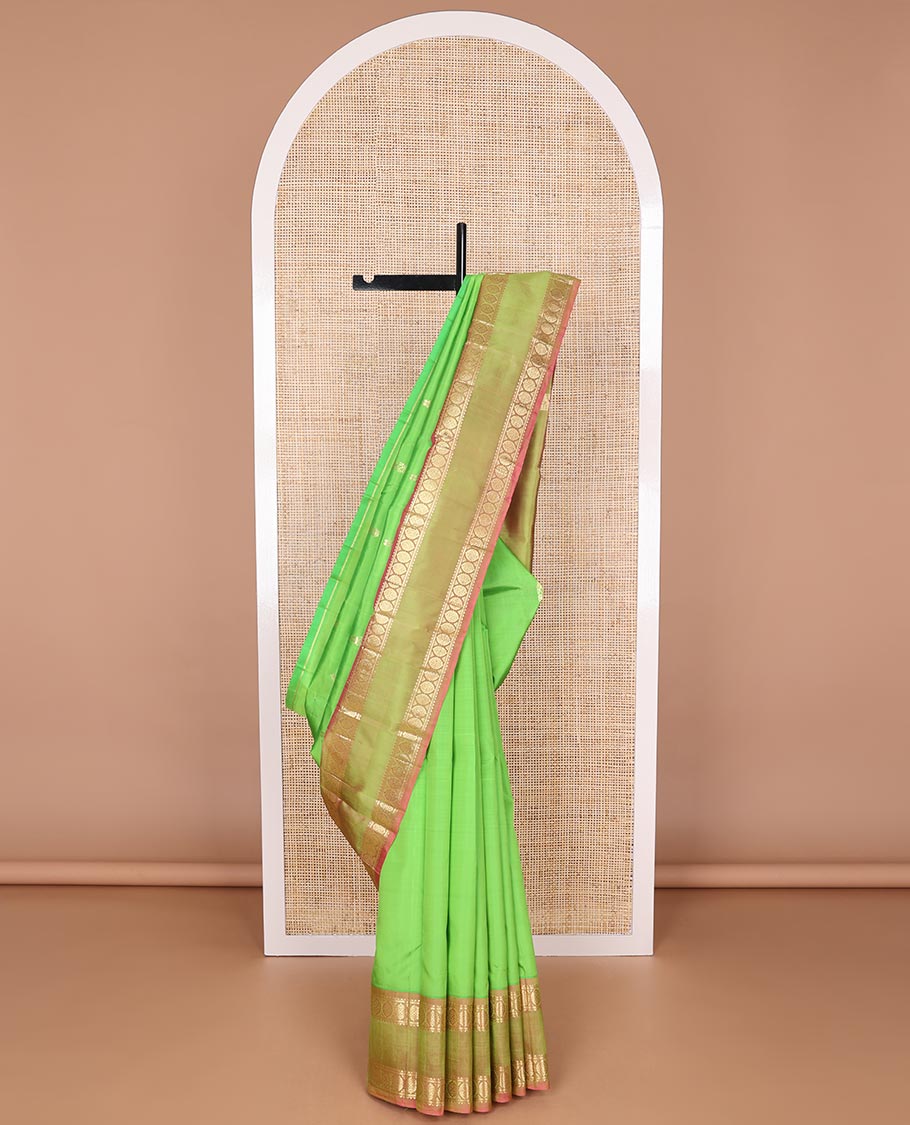 Orange Vasundhara Silk Saree Elegantly Woven with Zari Buttas, Complemented by a Contrast Varisai Pettu Border of  Salngai, Neli, Mayil, and Kodi Visiry Designs, Zari-Rich Jaal Pallu, and Paired with a Contrast Zari-Bordered Blouse