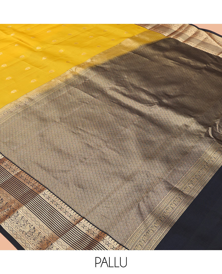 Yellow Vasundhara Lite-Silk Mix Saree Decked Up with Zari Buttas, Complemented by a Contrast Black Border Depicting Manga, Muthu, Kamalam, Banaras, Diamond, and Mayil Designs, Pallu Steeped with Diagonal Leaf Vines, and a Contrast Blouse