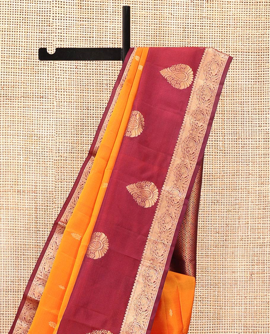 Orange Vasundhara Lite Silk Mix Saree, Subtly Sparkled with Zari Buttas All Over Its Body, Complemented by a Contrast Border of Thilakam, Kamalam, and Round Mayil Designs, Intricately Designed Pallu, and Paired with a Contrast Blouse