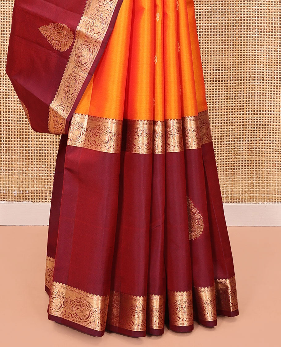 Orange Vasundhara Lite Silk Mix Saree, Subtly Sparkled with Zari Buttas All Over Its Body, Complemented by a Contrast Border of Thilakam, Kamalam, and Round Mayil Designs, Intricately Designed Pallu, and Paired with a Contrast Blouse