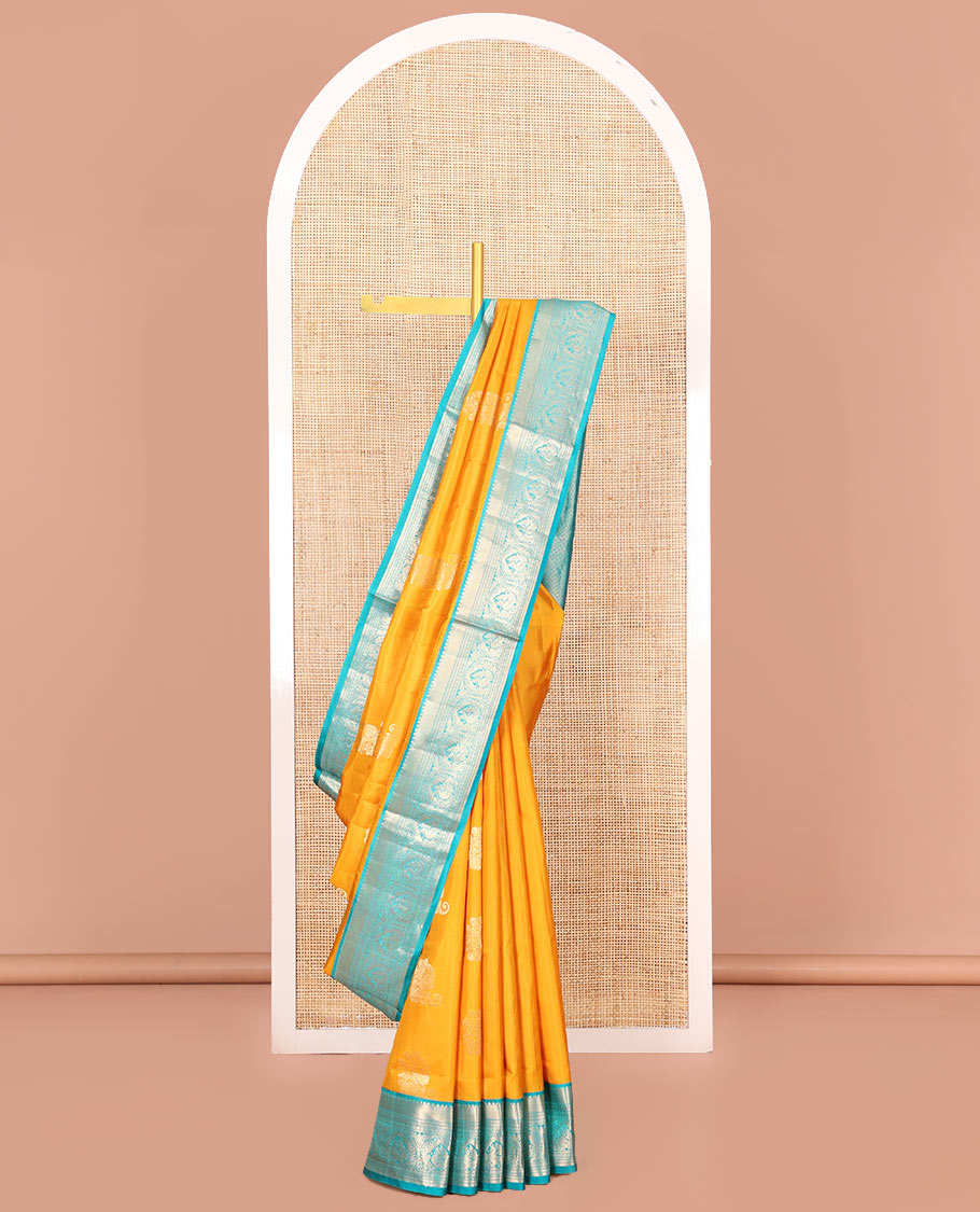 Yellow Vasundhara Silk Saree Ornamented with Zari Buttas All Over Its Body, Complemented by a Contrast Border of Neli, Kathir, Rudraksham, and Mayil Designs, Pallu Featuring Jaal Designs, and Paired with a Contrast Blouse