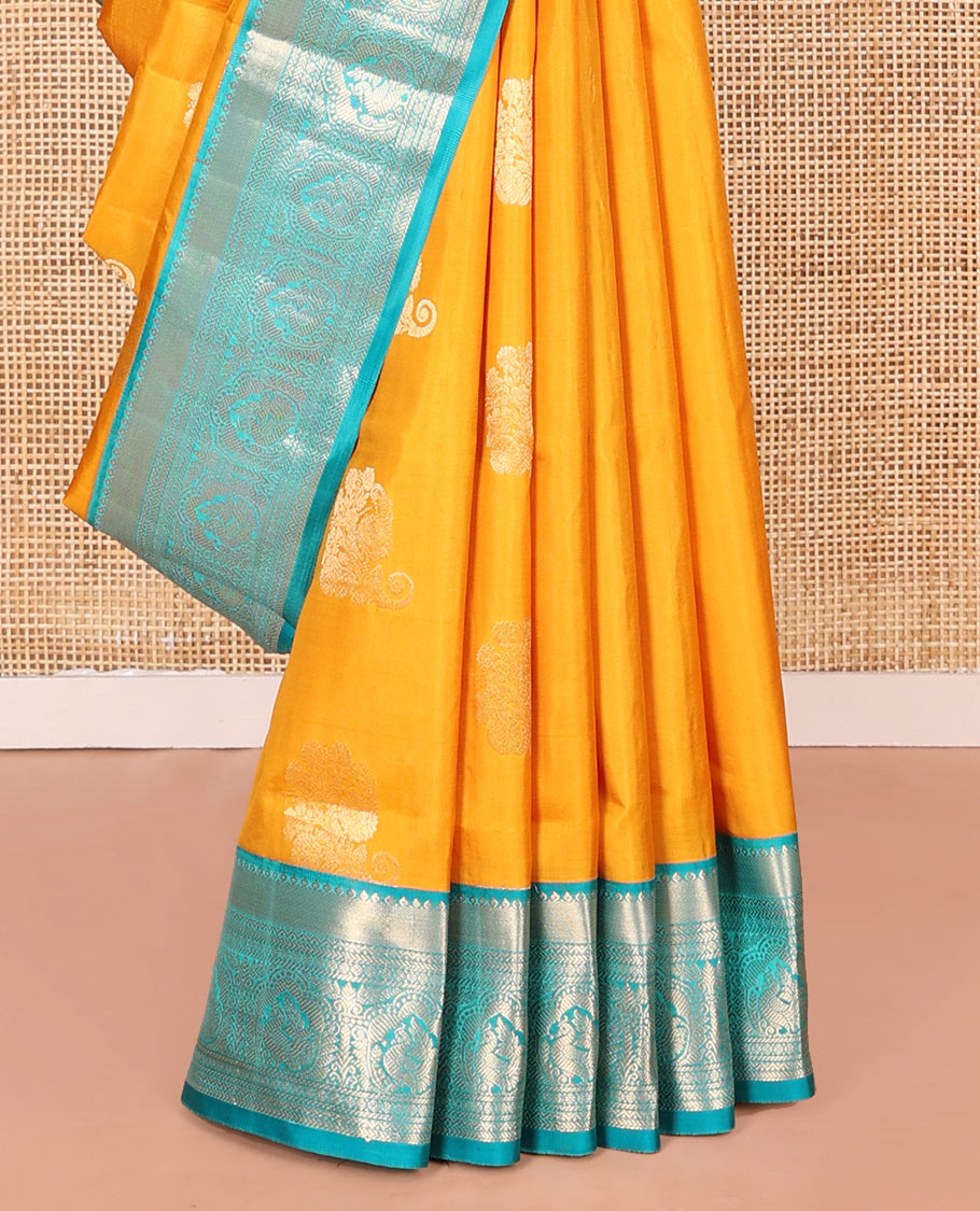 Yellow Vasundhara Silk Saree Ornamented with Zari Buttas All Over Its Body, Complemented by a Contrast Border of Neli, Kathir, Rudraksham, and Mayil Designs, Pallu Featuring Jaal Designs, and Paired with a Contrast Blouse