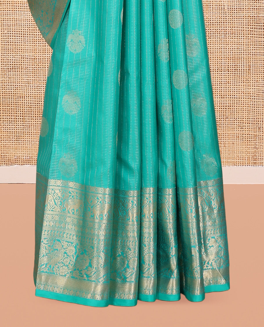 Blue Vasundhara Silk Saree, Accentuated with Zari Buttas and Stripes, a Zari Border of Kathir, Yaanai, Rudraksham, Manga, and Mayil Design, a Grand Pallu, and a Matching Blouse