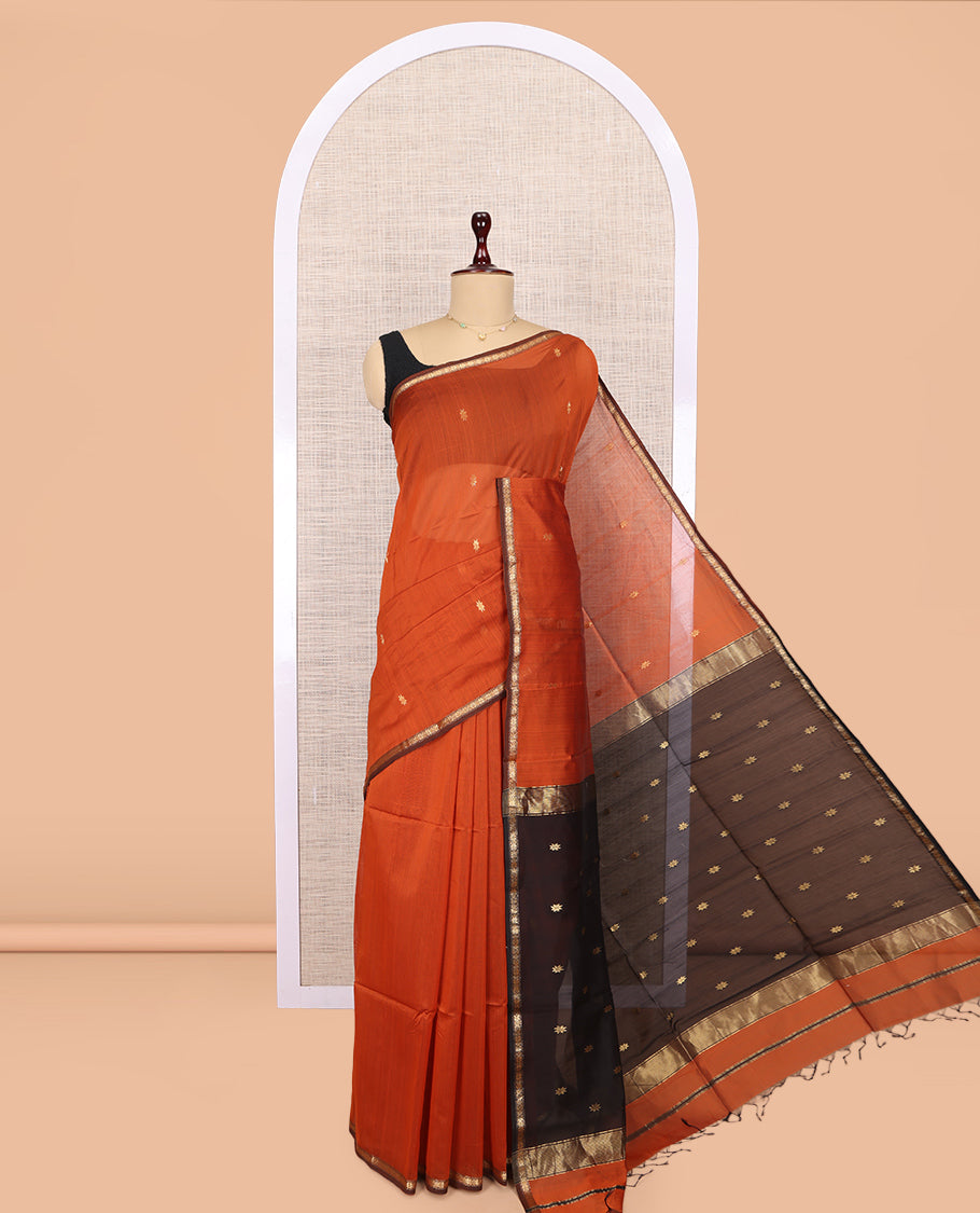 Orange Maheshwari Cotton Saree, Adorned with Buttas, a Subtle Contrast Piping Border, Pallu Gleamed Up with Zari Buttas, and a Contrast Blouse