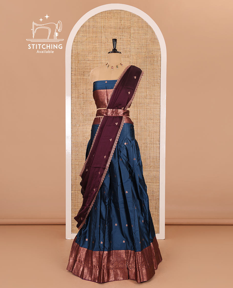 Blue taffeta silk half-saree, zari buttas with contrast traditional zari bordered skirt, matching zari design blouse, and contrast scallop buttas embroidered dhavani