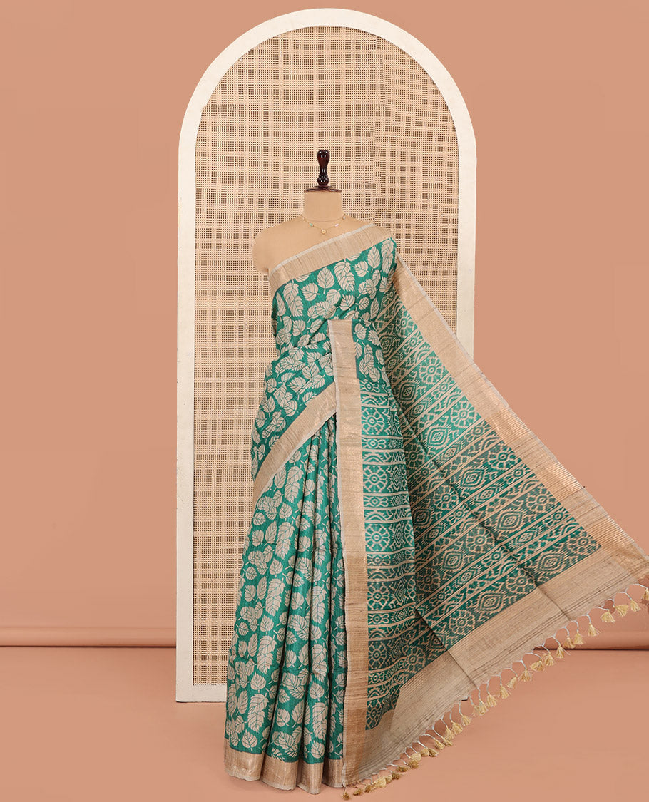Green Tussar Silk Saree Accentuated with Leaf Motifs Printed All Over Its Body, Featuring a Contrast Border, Complemented by Contrast Pallu of Ikkat-Style Print, and Paired with a Matching Blouse